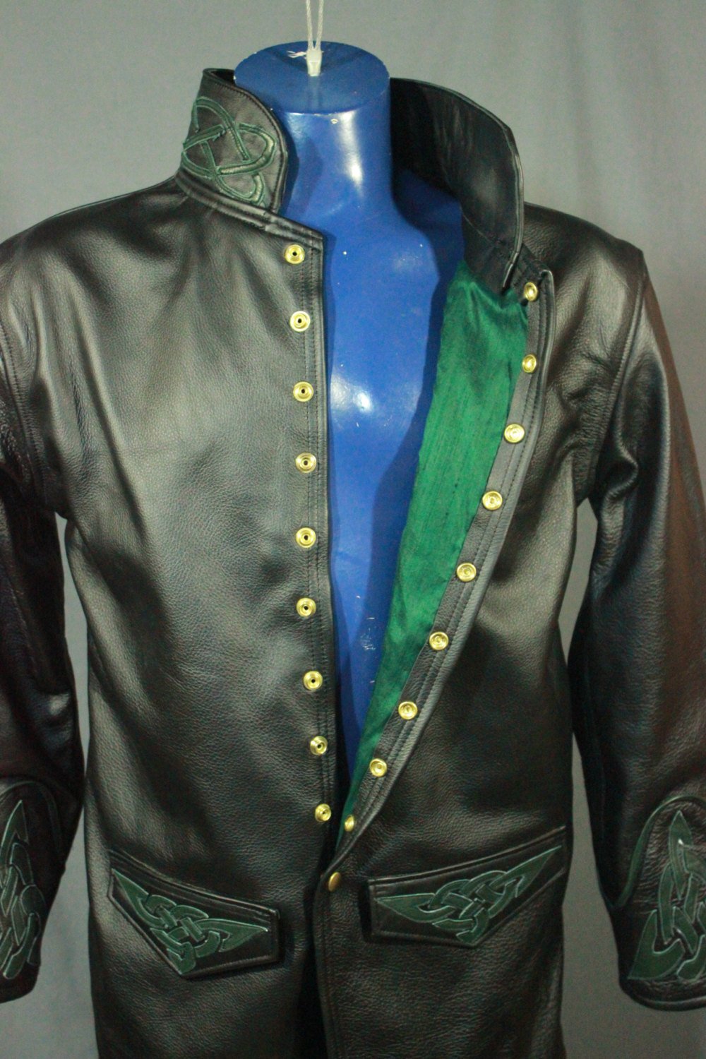 Leather dress coat with celtic highlights in forrest green.