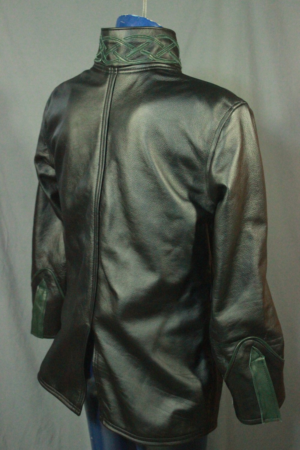 Leather dress coat with celtic highlights in forrest green.